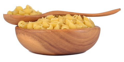 Uncooked italian pasta shells in a wooden bowl on a white