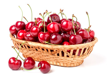 cherries in a wicker basket isolated on white background