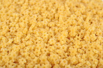 Uncooked italian pasta stars as background
