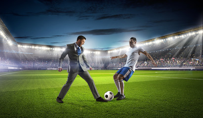 Businessman and player fighting for ball