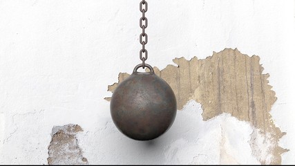 Metallic rusty wrecking ball on chain, with old wall. 3D rendering