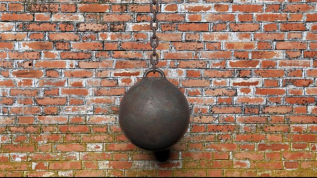 Metallic rusty wrecking ball on chain,with old brick wall background 3D rendering © viperagp