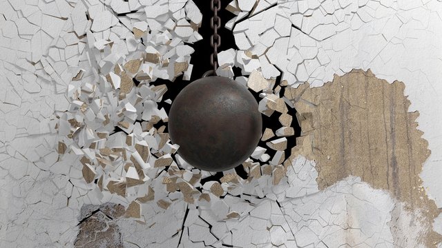 Metallic rusty wrecking ball on chain shattering  an old wall. 3D rendering