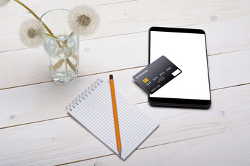 Fototapeta premium Credit card, tablet and notebook with pencil on the table