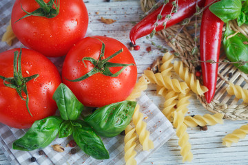 Italian food background, with tomatoes, basil, pasta, olive oil,