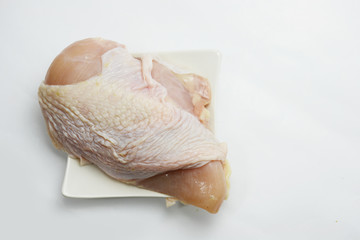 chicken for cooking on white plast