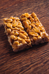Kozinaki of peanut on a wooden background