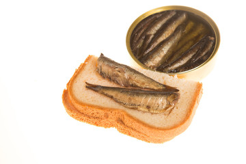 Open can and sandwich of sprats on a isolated background