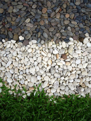 Background of grey, white rocks and green grass