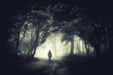 man on forest path in fog