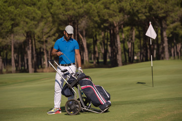 golf player walking with wheel bag