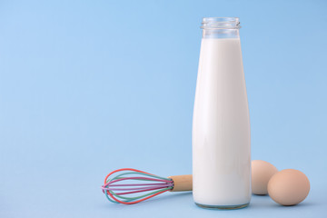 Milk and eggs on blue background