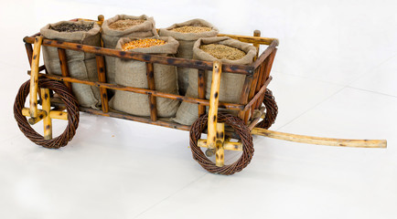 Wheelbarrow with grains in sacks