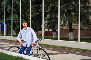 young hipster man with fixed gear bike on city street