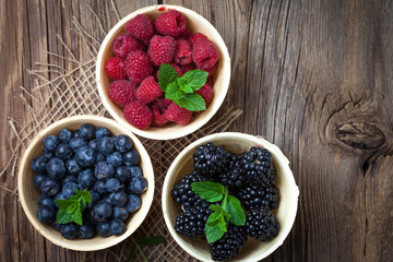 Blackberries, raspberries and blueberries in a waffle bowls.