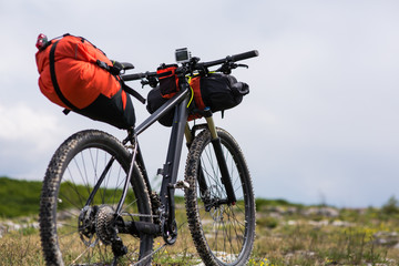 Fototapeta na wymiar Bicycle with orange bags for travel