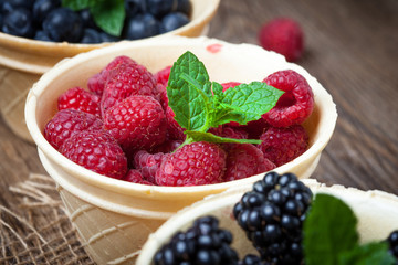 Blackberries, raspberries and blueberries in a waffle bowls.