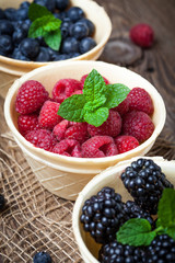Blackberries, raspberries and blueberries in a waffle bowls.