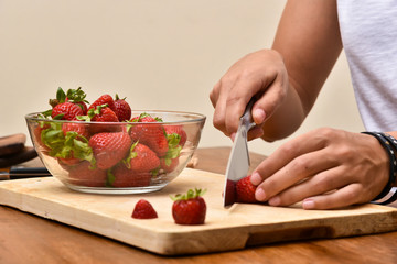 Slicing strawberries on a wooden table