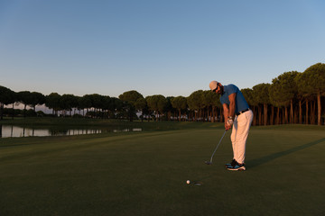 golfer  hitting shot at golf course