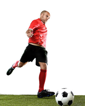 football player kicking ball in free kick shooting action isolated on white background on green grass pitch