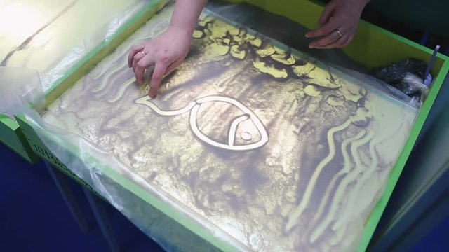 Hand draw sand on glass close-up