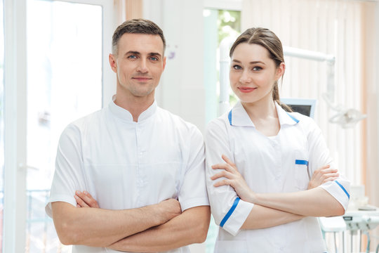 Portrait of a confident male and female dentists smiling