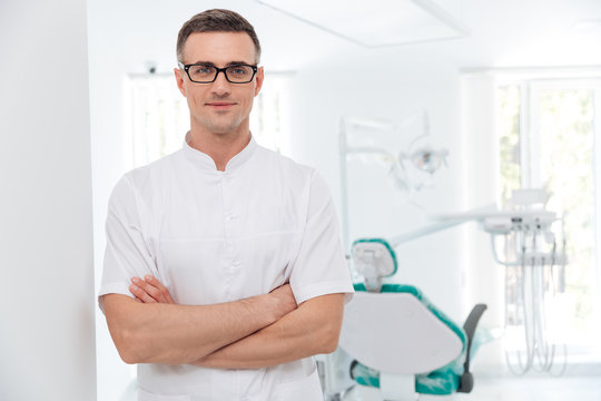 Female dentist standing with his hands crossed
