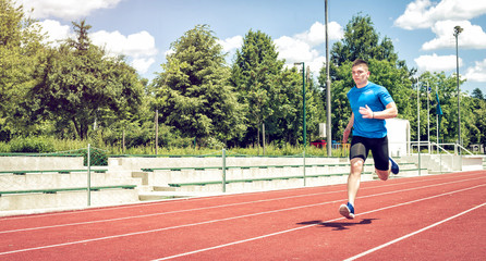 Running fast on athletic field track.