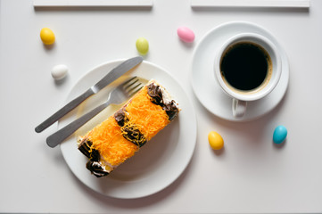 Coffee and cake on light table, closeup flat lay style top view