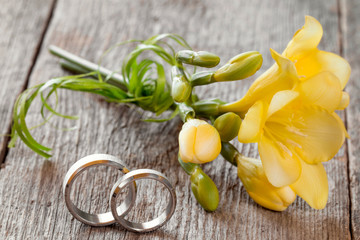 Wedding rings with freesia flower