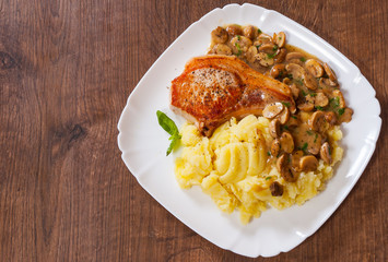 grilled meat fillet steak with Mushroom Sauce and mashed potato in a plate on wooden table