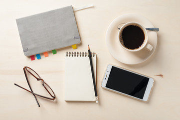 Small notebook and coffee cup