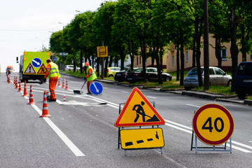 road works, painting of road lanes, selective focus on road sign