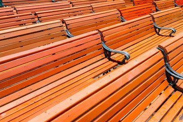 Pattern of wet red wooden benches
