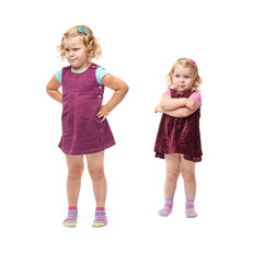 Couple young little girls standing over isolated white background