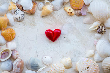 love concept with red heart shape and sea shell frame on white c
