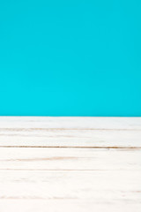 White wooden floor and blue background
