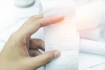 Paper cash register receipts in a lose pile close up with soft f