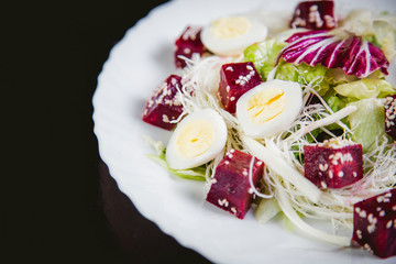 Buriak salad, greens and perepelin?h eggs, sesame