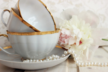 pale pink peonies with porcelain cups and saucer