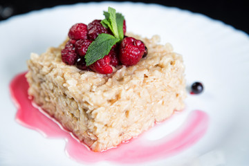 English oatmeal with berries and honey on a plate