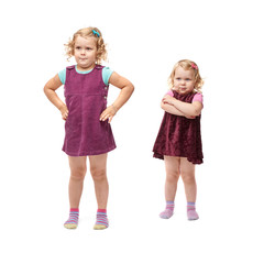 Couple young little girls standing over isolated white background