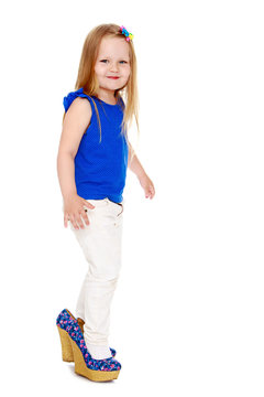 Funny little girl in mom's shoes-Isolated on white background