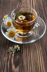 Healthy tea with chamomile in glass cup