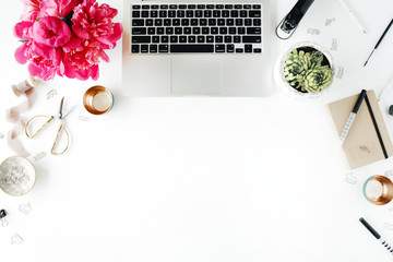 Fototapeta premium Workplace with laptop, succulent, peonies, golden scissors, spool with beige ribbon, pencils and diary. Flat lay composition for bloggers, magazines, social media and artists. Top view.