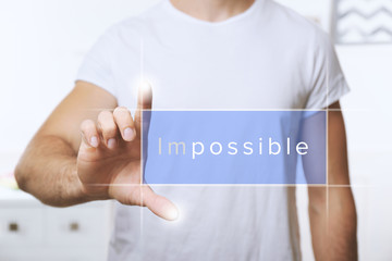 Human hand turning word impossible into possible