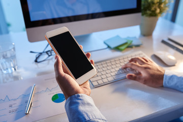 Business person reading text message on his smartphone