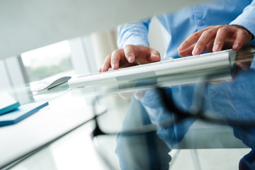 Cropped image of business person typing on keyboard