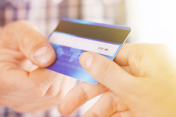 Hands holding a credit card